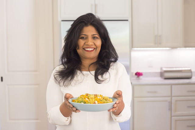 Chef Asha Gomez with her Weeknight Fancy Chicken and Green Bean Verraka